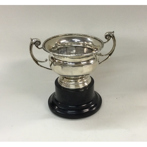 370 - A silver two handled cup on plinth base. Birmingham 1939. By William Neale Ltd. Approx. 115 grams. E... 