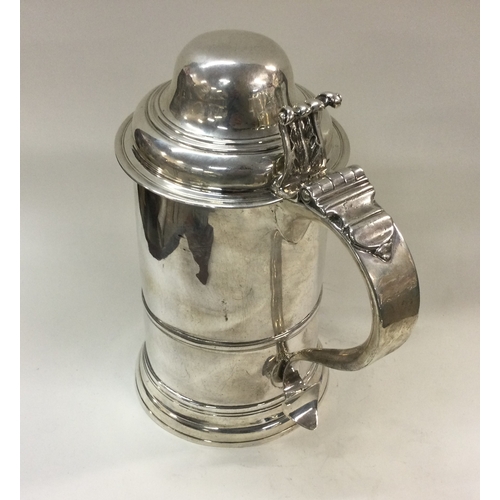 372 - A large 18th Century George III crested lidded silver tankard. London 1764. Approx. 685 grams. Est. ... 