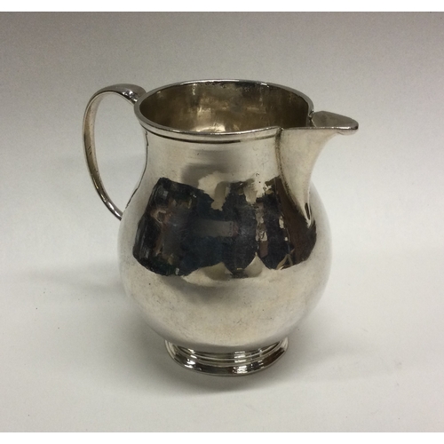 459 - A good Georgian baluster shaped sparrow beak cream jug. Approx. 85 grams. Est. £150 - £250.