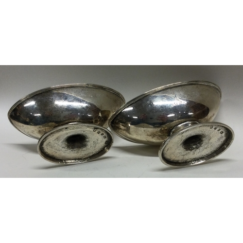 465 - A heavy pair of Georgian silver boat shaped salts with gilt interiors. London. By IY. Approx. 228 gr... 