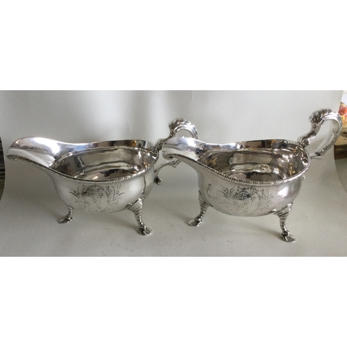 490 - A good pair of Georgian silver sauceboats with crested sides. London 1747. Approx. 790 grams. Est. £... 