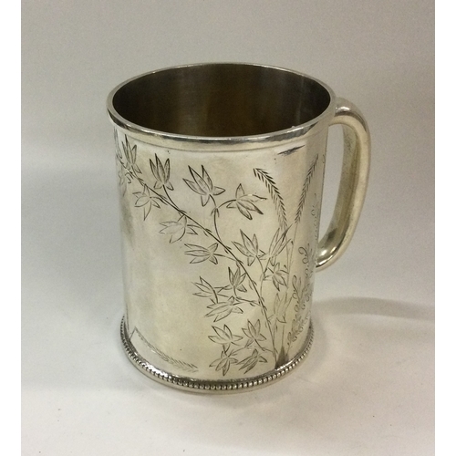 511 - A Victorian silver mug engraved with leaves. London 1880. By Joseph Walton. Approx. 125 grams. Est. ... 