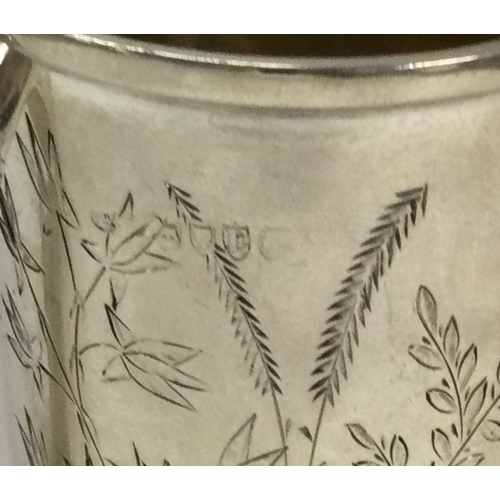 511 - A Victorian silver mug engraved with leaves. London 1880. By Joseph Walton. Approx. 125 grams. Est. ... 