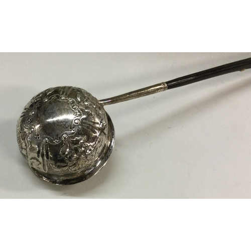 515 - A chased George III silver toddy ladle with whalebone handle. Approx. 39 grams. Est. £30 - £50.