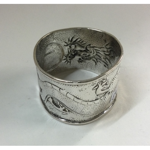 84 - A good Chinese silver napkin ring. Punched to interior. Approx. 29 grams. Est. £30 - £40.