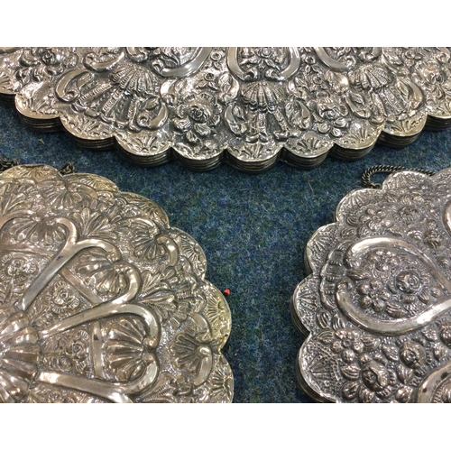 478 - A good set of three Continental silver mirrors. Est. £250 - £350.