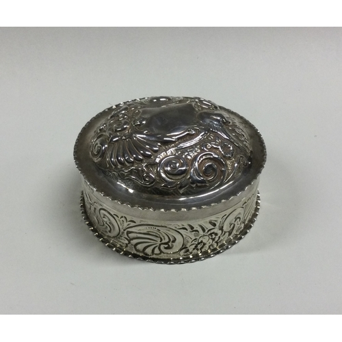 75 - A good embossed silver dressing table box and cover. London. Approx. 91 grams. Est. £60 - £80.