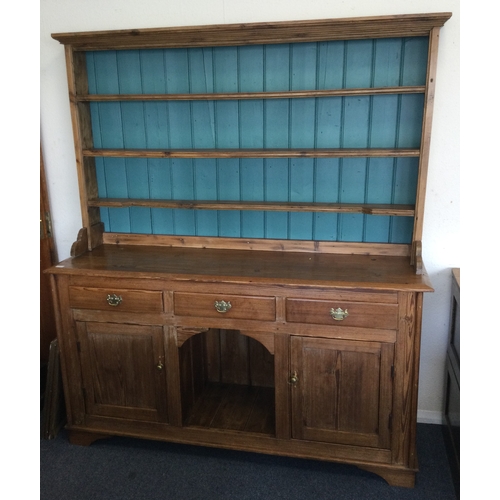 A large striped pine kitchen dresser.