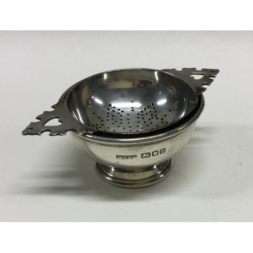 110 - A heavy silver tea strainer on stand. London 1946. By W Batty & Sons. Approx. 105 grams. Est. £100 -... 