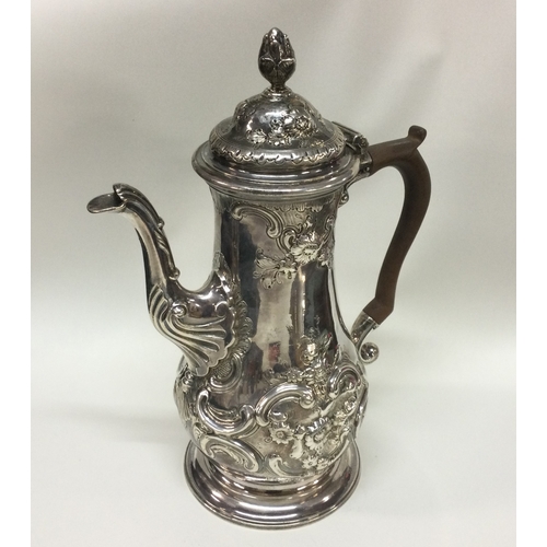 230 - A chased George III silver coffee pot. London 1769. By John Bayley. Approx. 840 grams. Est. £800 - £... 