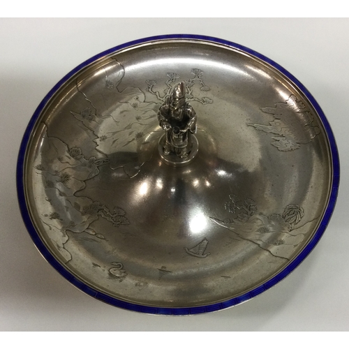 231 - A large silver and enamel dish chased with a river scene and temples. Possibly Chinese? Circa 1920. ... 