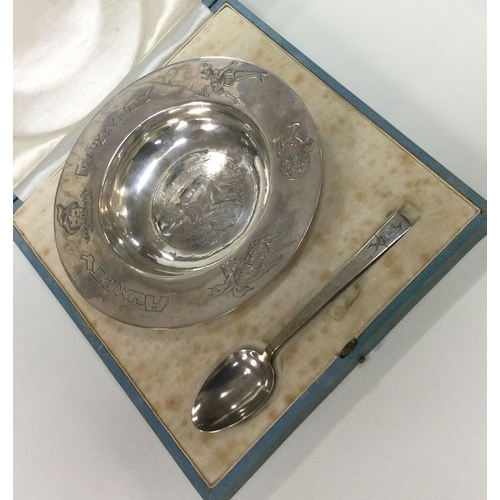 235 - A rare silver christening set with 'Humpty Dumpty' decoration in original case. London 1938. Approx.... 
