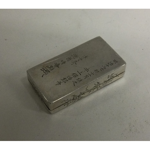 10 - A Japanese silver box with engraved decoration. Signed to base. Approx. 24 grams. Est. £60 - £80.