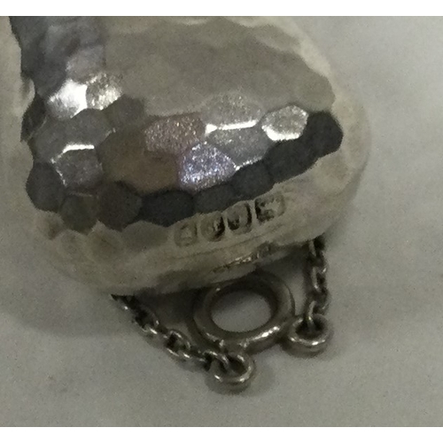 124 - A silver scent bottle with screw-on lid and safety chain with hammered decoration bearing import mar... 