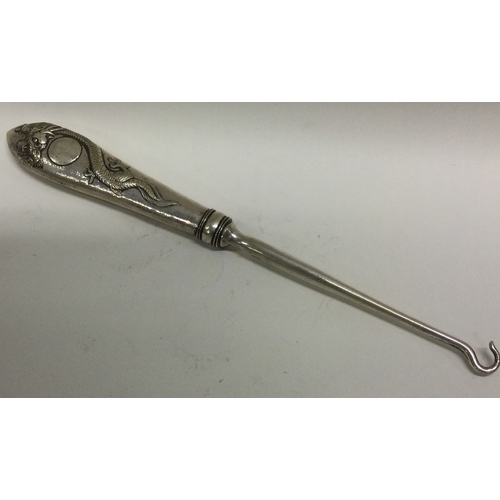 15 - A large Chinese silver hook, possibly of medicinal interest. Approx. 68 grams. Est. £80 - £120.