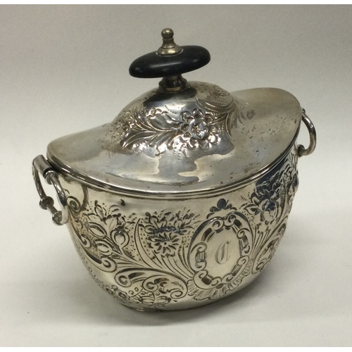 17 - A chased silver boat shaped tea caddy. Approx. 137 grams. Est. £30 - £40.