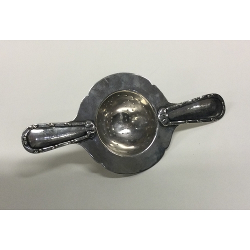 24 - An Art Deco silver tea strainer. Approx. 50 grams. Est. £60 - £80.