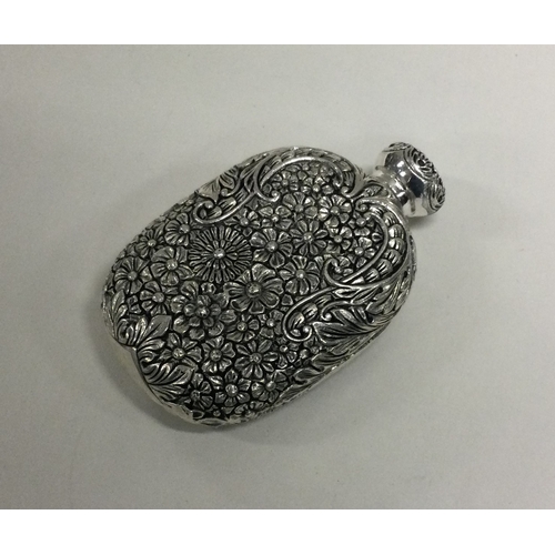 28 - A heavy chased silver scent bottle of Chinese design. Approx. 89 grams. Est. £200 - £300.