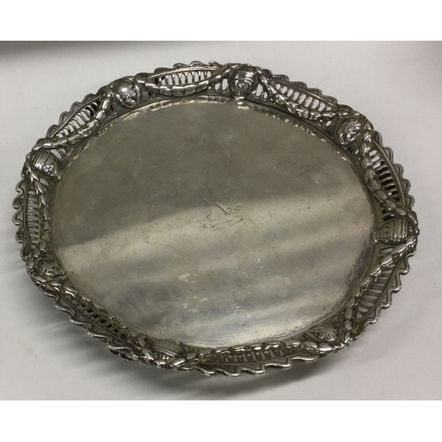 30 - An early 18th Century cast silver tray with pierced border and embossed decoration. London 1771. By ... 