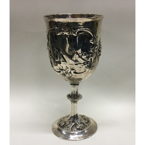 152 - A chased Victorian silver goblet decorated with river scenes. Circa 1870. Approx. 146 grams. Est. £2... 