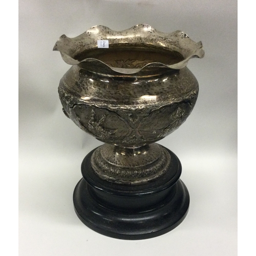 18 - An Indian shaped silver bowl decorated with figures. Approx. 269 grams. Est. £40 - £60.