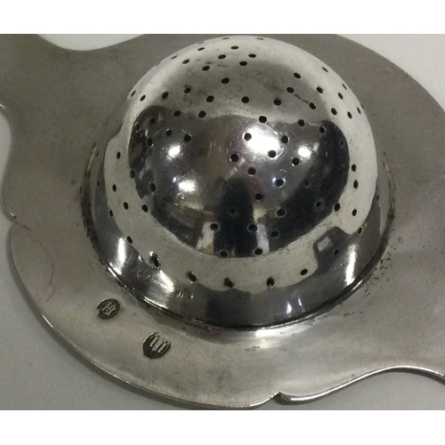 24 - An Art Deco silver tea strainer. Approx. 50 grams. Est. £60 - £80.