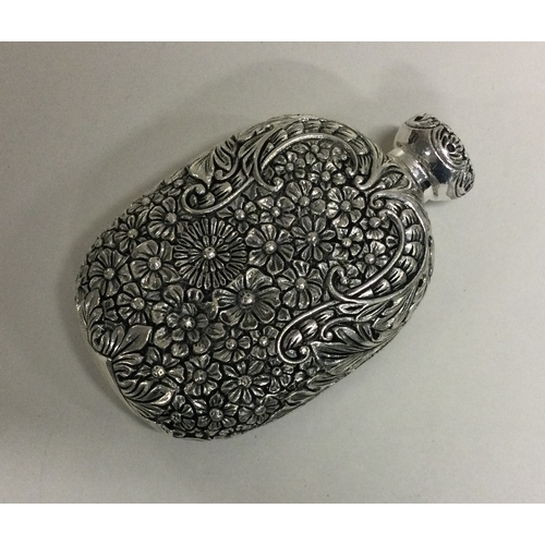 28 - A heavy chased silver scent bottle of Chinese design. Approx. 89 grams. Est. £200 - £300.