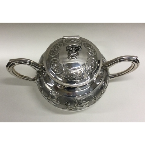 31 - A Chinese export silver two handled cup with hinged lid chased with bamboo decoration. Marked to bas... 