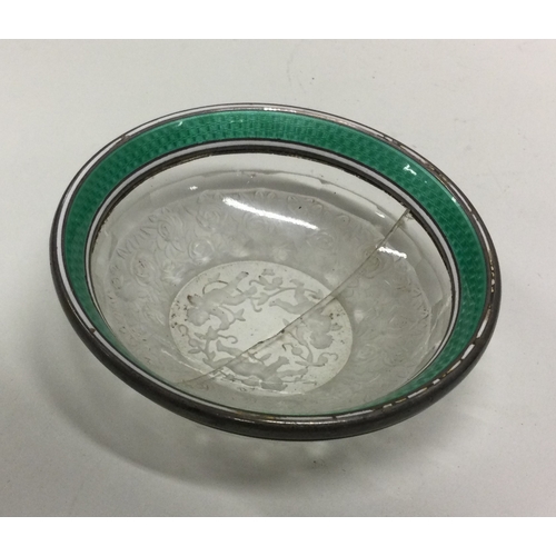 50 - A silver and enamel rock crystal dish bearing import marks. Approx. 113 grams. Est. £100 - £150.