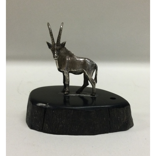 51 - PATRICK MAVROS: A silver figure of an antelope on wooden base. Approx. 40 grams. Est. £60 - £80.