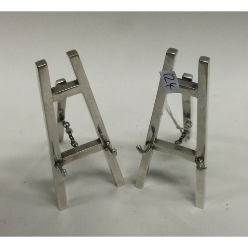 124 - A good pair of miniature silver plated menu holders in the form of easels. Approx. 167 grams. Est. £... 