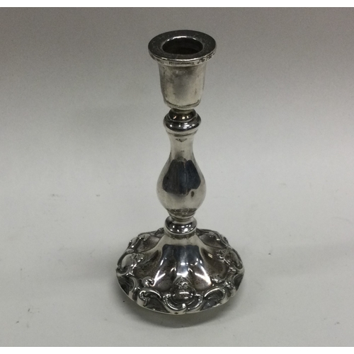 144 - A small silver chamber stick with scroll decoration. London. By HW. Approx. 79 grams. Est. £20 - £30... 