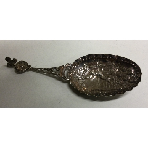 152 - An oversized chased silver caddy spoon bearing German import marks. Approx. 35 grams. Est. £50 - £80... 