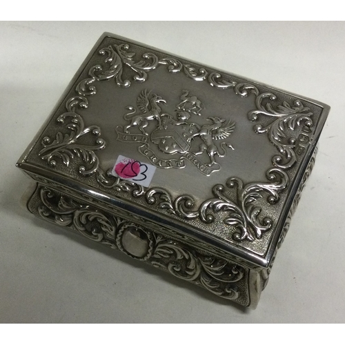 153 - A large novelty Victorian silver chased table snuff box. London 1895. By John Macleod Crouch. Approx... 