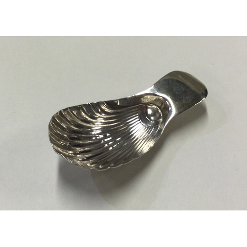 17 - A George III silver caddy spoon with fluted bowl. Circa 1810. Approx. 7 grams. Est. £40 - £60.