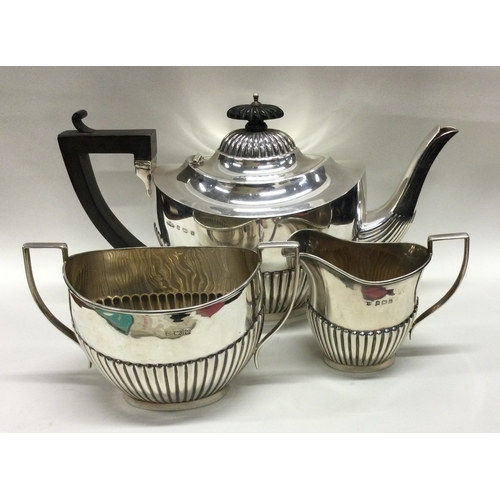 184 - A good silver half fluted three piece tea set. Birmingham. Approx. 716 grams. Est. £200 - £300.