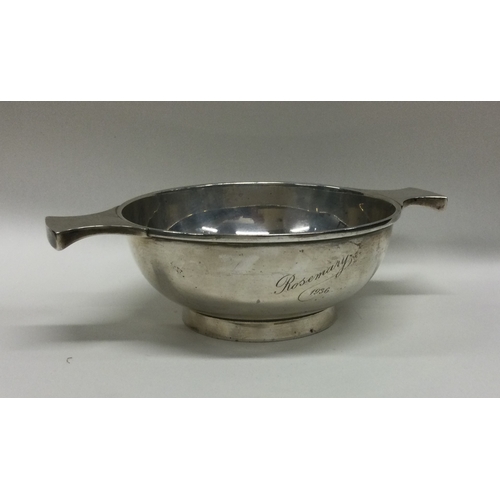 21 - A heavy silver two handled porringer on pedestal foot. Approx. 153 grams. Est. £60 - £80.