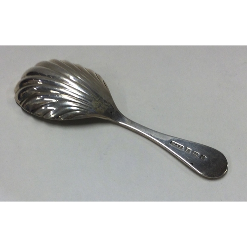 243 - A silver fluted caddy spoon. Birmingham. By CR. Approx. 18 grams. Est. £15 - £20.