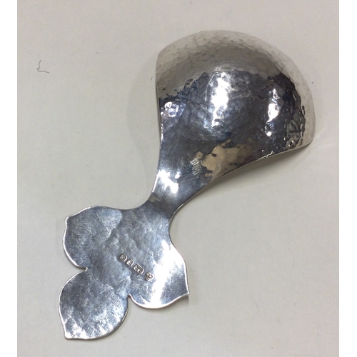 246 - A large silver caddy spoon with leaf decoration. London. By CS. Approx. 31 grams. Est. £40 - £50.