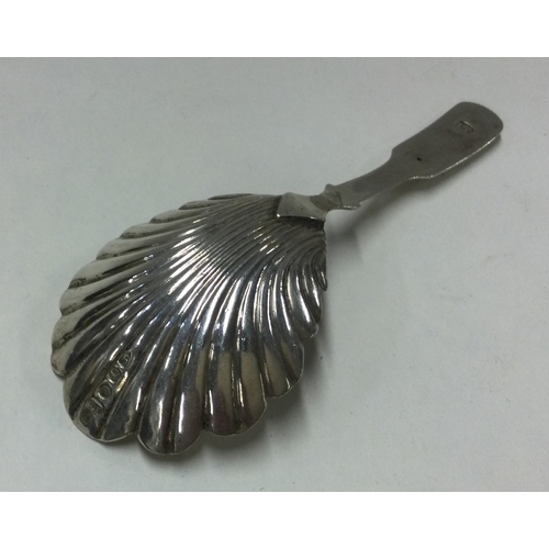 249 - A George III fluted silver caddy spoon. Birmingham. By John Taylor. Approx. 8 grams. Est. £45 - £55.