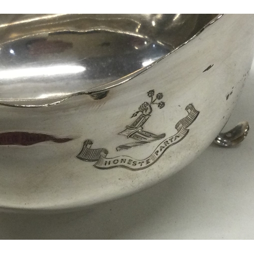 255 - A crested silver Georgian style silver sauce boat. Sheffield. Approx. 185 grams. Est. £65 - £75.