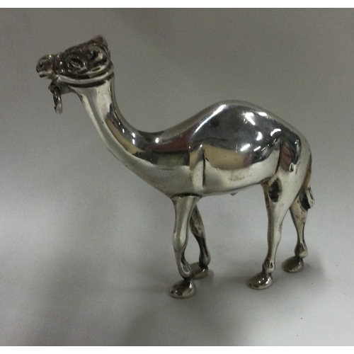 263 - A heavy cast silver figure of a camel. Approx. 185 grams. Est. £150 - £200.