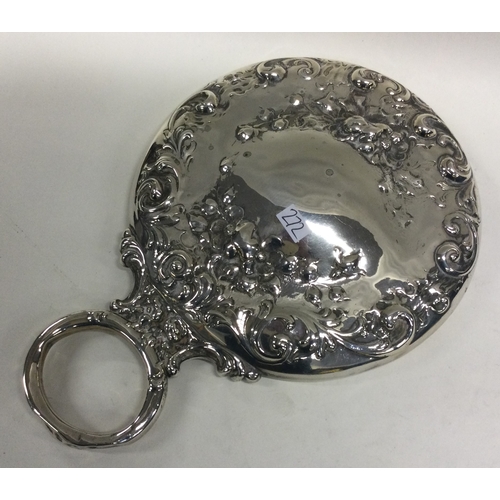 272 - A chased silver dressing table mirror. Est. £20 - £30.