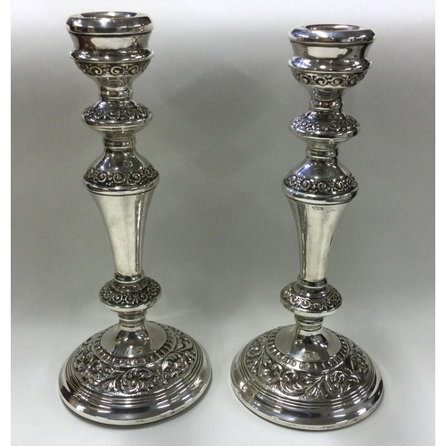 279 - A pair of large heavy chased silver candlesticks. Birmingham 1972. Approx. 998 grams gross weight. E... 