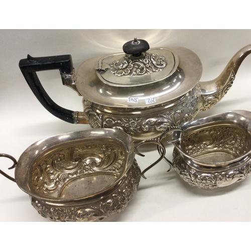 292 - A good chased silver three piece tea service. Approx. 883 grams. Est. £300 - £400.