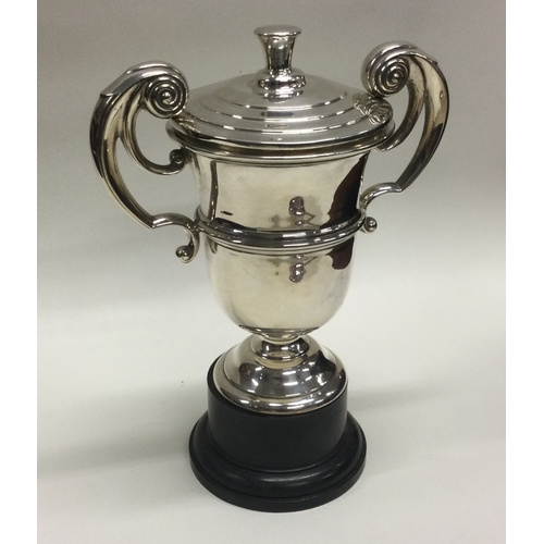 309 - A plain silver trophy cup and cover. Sheffield. By Walker & Hall. Approx. 295 grams gross weight. Es... 