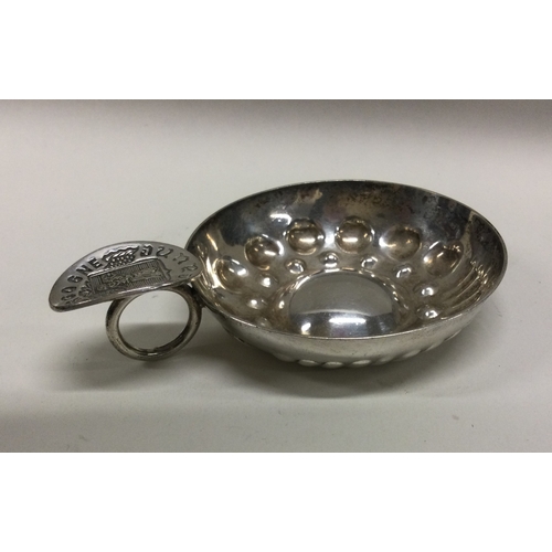 59 - A Georgian style silver wine taster with fluted bowl. Approx. 54 grams. Est. £25 - £30.