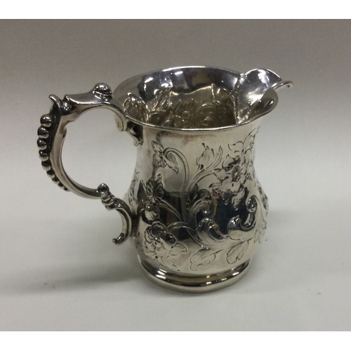 82 - WITHDRAWN: A heavy Victorian silver jug embossed with flowers. Birmingham. By SJ. Approx. 94 grams. ... 