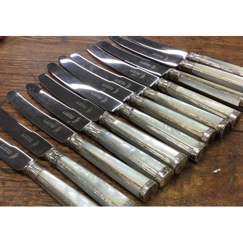 86 - A set of six silver table knives together with six silver dessert knives with MOP handles. Est. £60 ... 