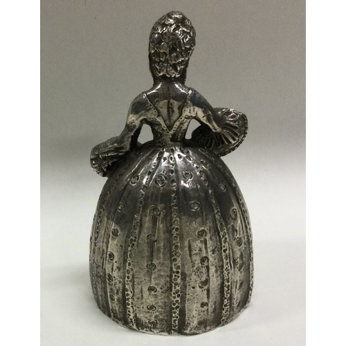 87 - A Continental silver table bell in the form of a lady in crinoline dress with dangling feet clipper.... 